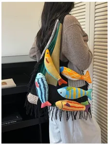 Chic knitted tote bag with cute plush fish accents and fringe details for casual daily style.