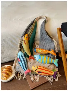 Detailed view of the casual knitted tote bag featuring colorful fish accents and fringe details.