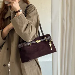 Elegant brown suede shoulder bag for women with chic metal turn-lock and vintage tote design.