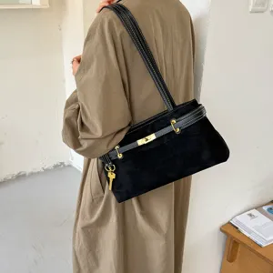 Elegant black suede shoulder bag with chic metal lock closure and vintage strap design.