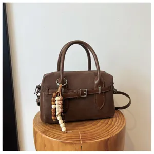 Retro brown suede boston handbag detail, stylish niche pillow crossbody bag for women.