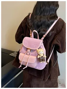 Pink casual backpack for women, stylish PU leather school bag with cute bear pendant.