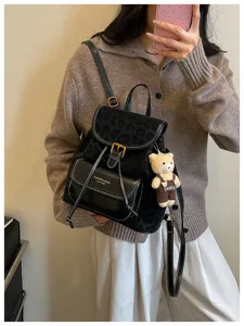 Korean style black leopard print backpack detail with front pocket and cute bear charm.
