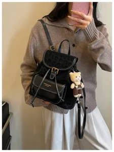 Stylish women casual backpack with leopard print flap and cute bear pendant detail.