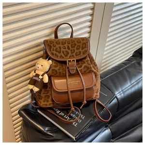 Stylish brown leopard print backpack with a cute bear pendant, perfect for daily casual wear.