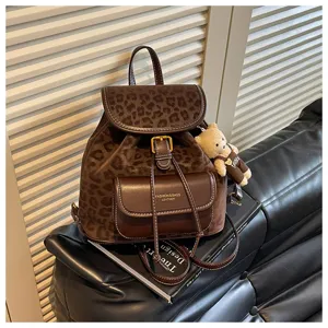 Brown leopard print backpack detail view, casual PU leather women school bag with cute bear.