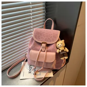 Detail view of pink Korean style casual backpack with leopard pattern flap and cute bear pendant.