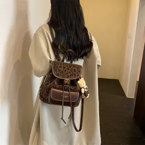 Korean casual leopard print backpack for women, stylish small daypack with bear pendant.