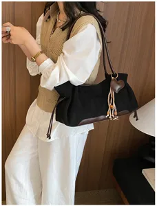 Retro suede underarm shoulder bag with brown leather trim and cute heart tassel detail.