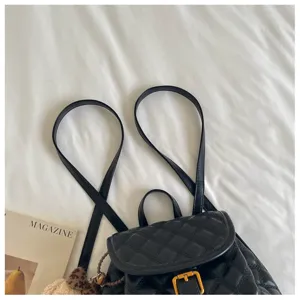 Detailed view of chic black quilted leather backpack, stylish travel and school bag.