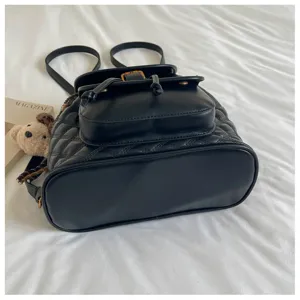 Black quilted leather mini backpack for women, casual travel daypack with drawstring closure.