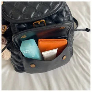Black quilted leather backpack casual vintage travel school bag detail front pocket capacity display.
