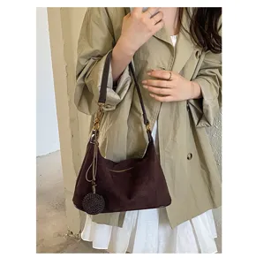Brown suede underarm shoulder bag for women with chic woven pendant and metal zipper closure.