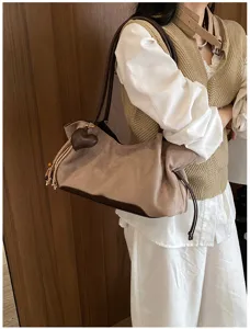 Detailed view of the retro women shoulder bag, elegant brown suede underarm style design.