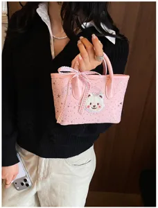 Pink tote bag with cute bear patch and bow, stylish casual handbag for daily commuting travel.