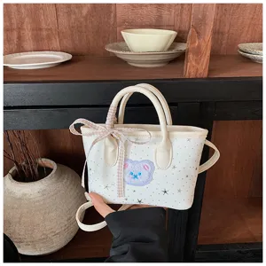 Small white crossbody tote bag for women with cute bear patch, plaid ribbon and star details.