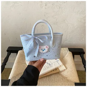 Light blue mini handbag detail featuring checkered ribbon bow, cute bear patch and star studs.