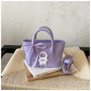 Detailed view of the purple PU leather handbag featuring cute astronaut patch and star studs.