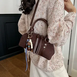 Bruine vintage stijl vrouwen schoudertas, crossbody handtas met chique tassels.
