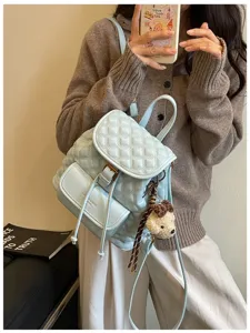 Light blue quilted leather backpack casual commuter travel book bag with cute bear charm.