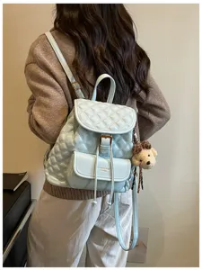 Light blue quilted leather casual backpack with drawstring and cute bear pendant charm detail.