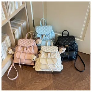 Casual vintage quilted leather backpack with cute bear pendant for travel and daily commute.