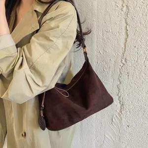 Dark brown suede shoulder bag for women, trendy underarm hobo bag with braided tassel.