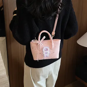 Stylish pink women's handbag crossbody shoulder bag with cute bow and plush patch.