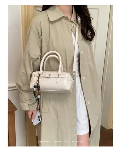 Chic minimalist patent leather pillow bag, stylish shoulder crossbody bag for women daily commute.