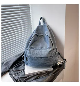 Vintage blauwe denim rugzak voor dames, casual schooltas met handige voorvak en sterke banden.
