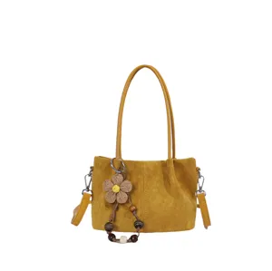 Yellow suede shoulder bag with floral bead charm, stylish casual tote for women.