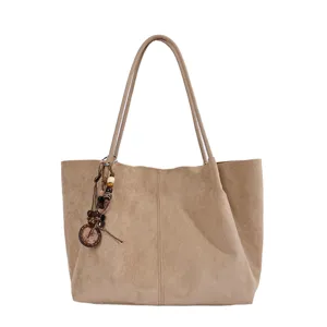 Beige Damen Schultertasche als große Tote Bag mit Perlenanhänger für den täglichen Weg zur Arbeit.