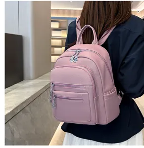Stylish pink faux leather backpack for women, large capacity, perfect for daily commute and travel.