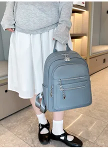 Detail view of the casual women backpack featuring multi-zipper pockets and chic metal pendants.