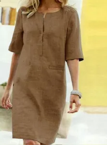 Detail view of brown linen short sleeve dress, V-neck design with casual relaxed fit.