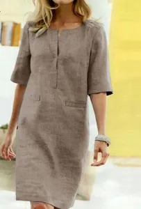Detail shot of the brown short sleeve linen dress showing V-neck design and fabric texture.