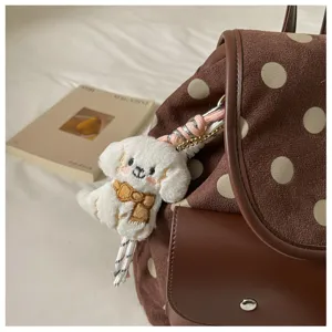 Korean polka dot backpack detail view, brown suede casual bookbag with cute puppy pendant.