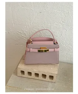 Pink minimalist retro handbag with gold hardware, elegant commuter chic stylish small square bag.