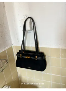 Zwarte suède schoudertas met metalen draaisluiting en dubbele hengsels voor dames.