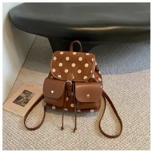 Chic Korean style polka dot backpack for women, large capacity casual commuter bag.