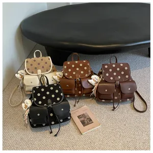 Details of Korean style polka dot backpack with cute bear charm and multi-pocket design.