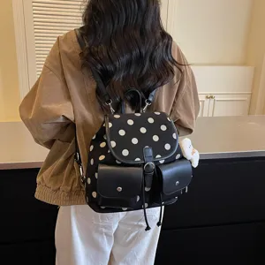 Stylish black and white polka dot backpack for women, large capacity casual daily commuter bag.