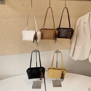Bolso de hombro minimalista coreano bajo el brazo color sólido bolso diario elegante.