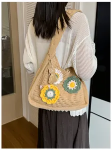 Detailed back view of a khaki knit crochet floral tote bag with cute dress pendant.