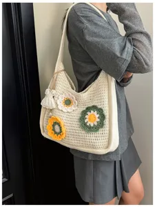 Detail view of the floral crochet tote bag, showcasing handmade hollow knit texture and charming style.