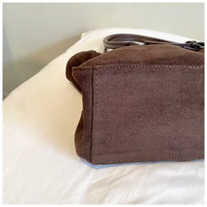 Close-up detail view of a brown suede large capacity shoulder tote bag, showing fine texture.