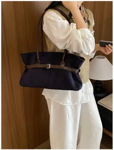 Chic retro dark blue shoulder tote bag with brown buckle strap, elegant daily commuter bag.