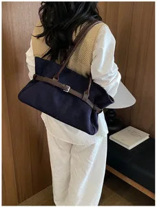 Detail shot of the retro navy blue tote bag with brown shoulder straps for women.