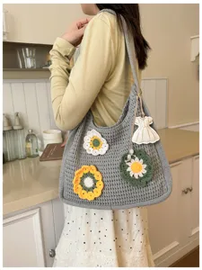 Detailed view of the gray crochet hollow knit tote bag featuring colorful flower appliques.