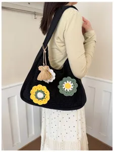 Black crochet floral knit hobo shoulder bag detailed view showcasing the handmade aesthetic.
